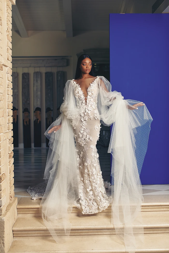 A model wears the Galia Lahav Fleur dress while descending stairs