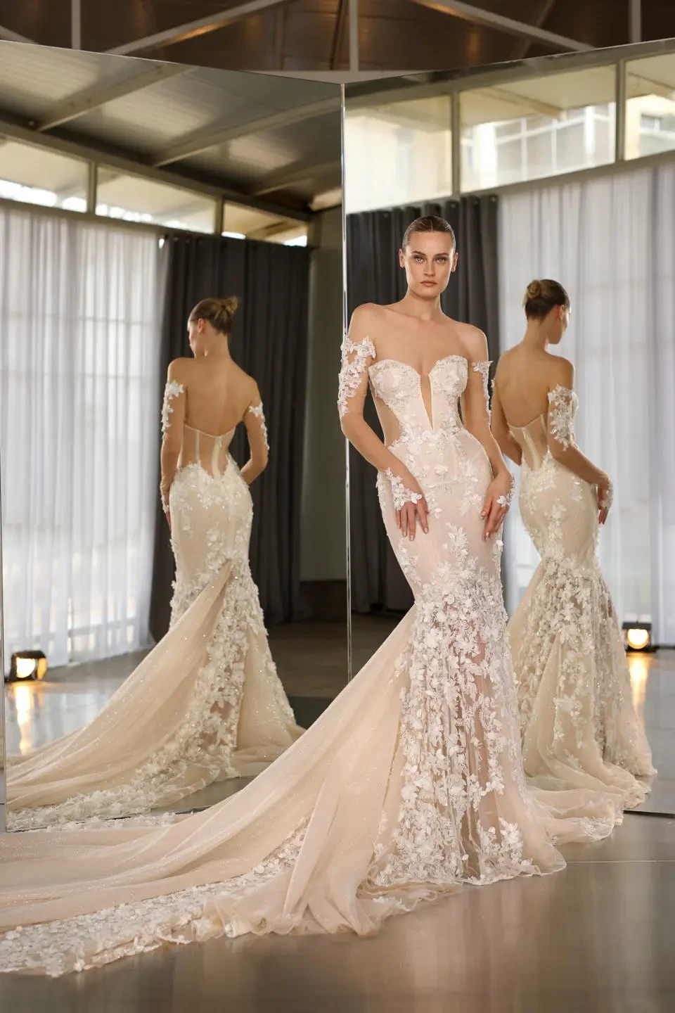 A model wears the Galia Lahav Nadia dress while standing in front of a mirror