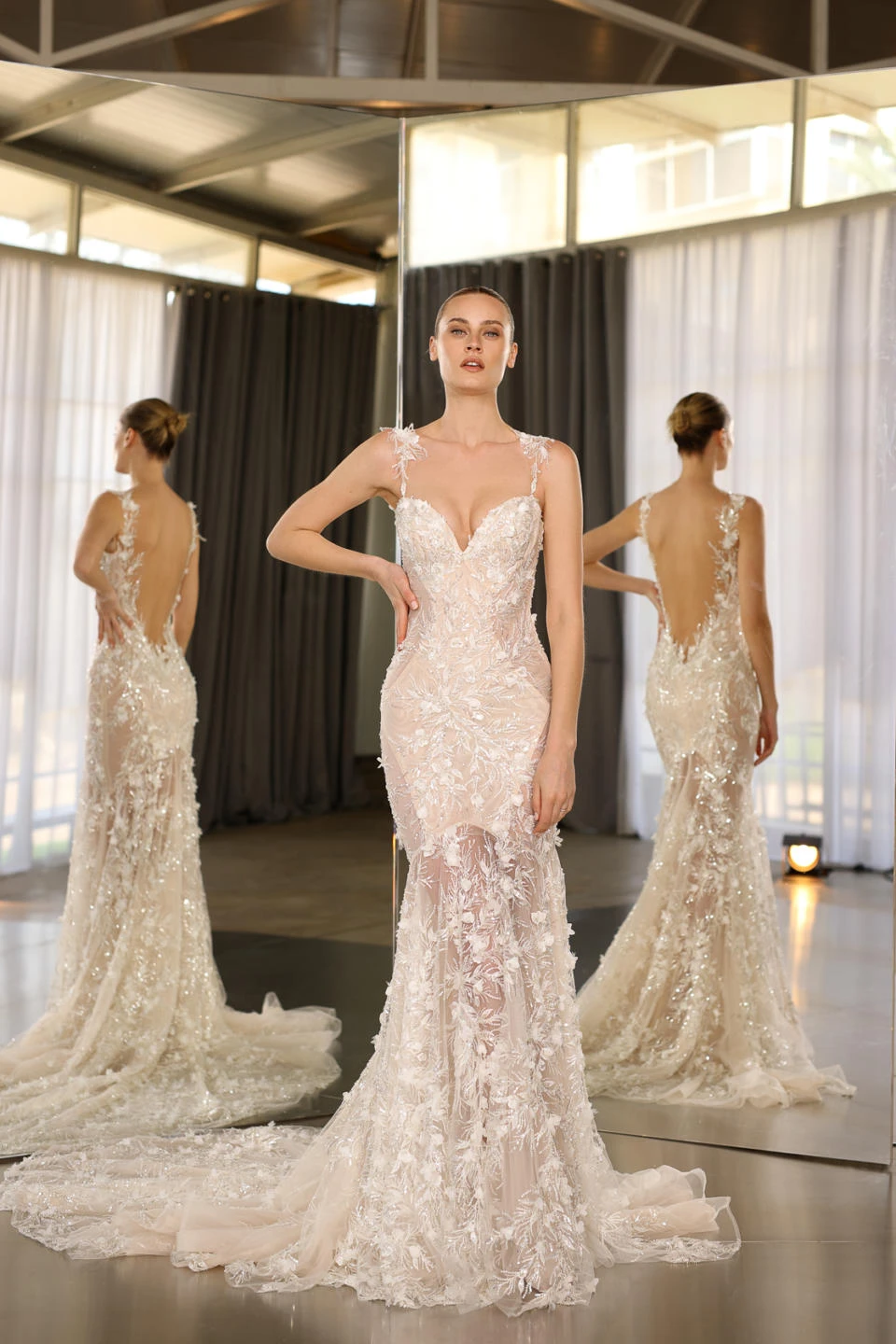 A model wears the Galia Lahav Shiloh dress in front of a mirror