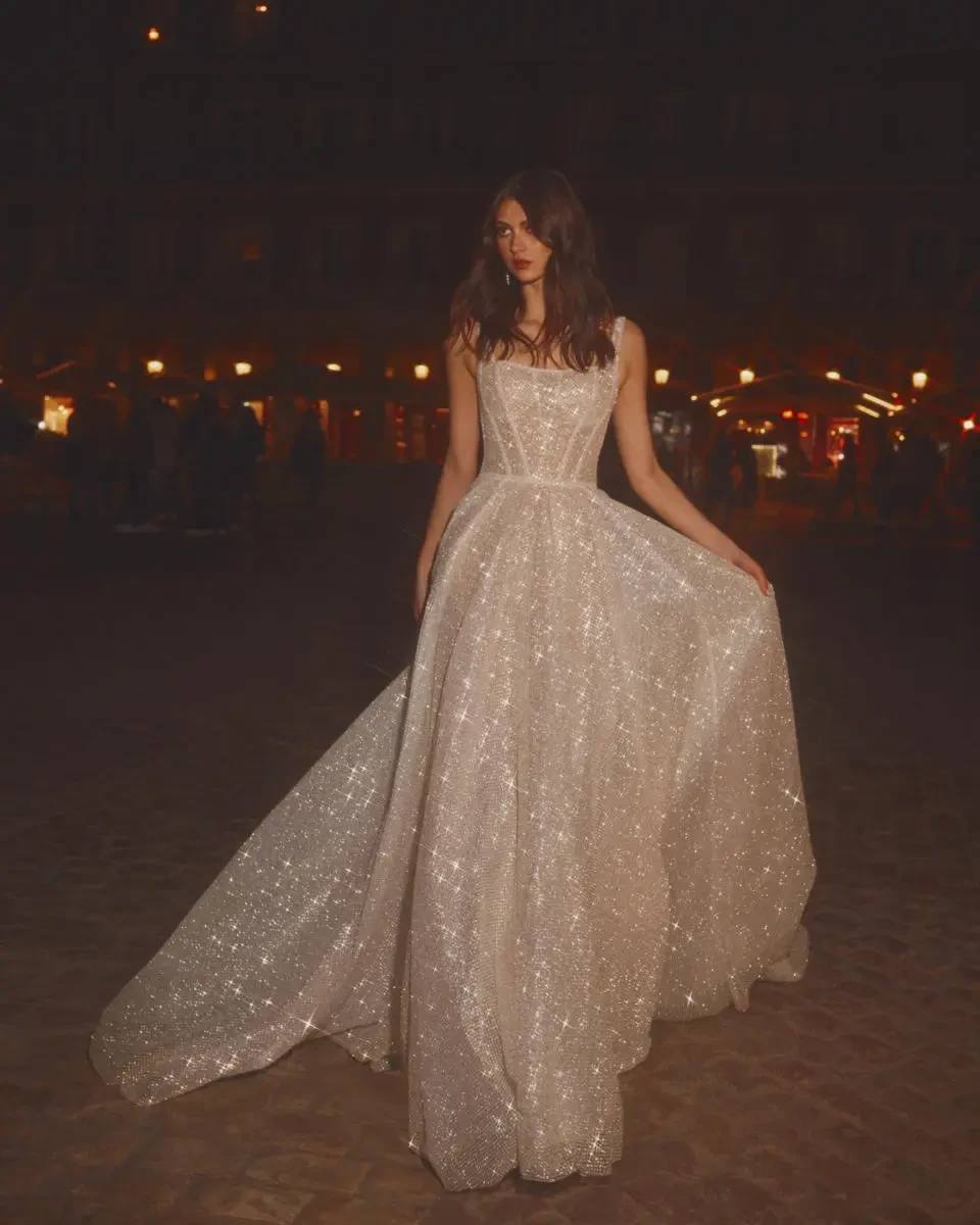 A model wears the Galia Lahav Gigi dress outside at night