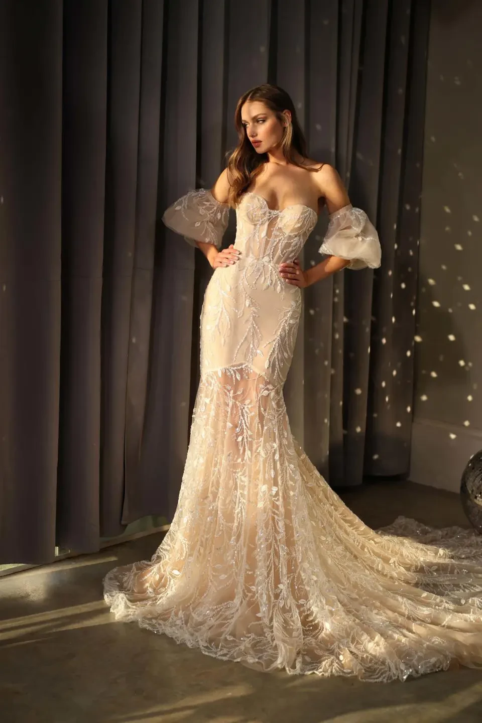 A model wears the Galia Lahav Jet dress in a ballroom with disco lights