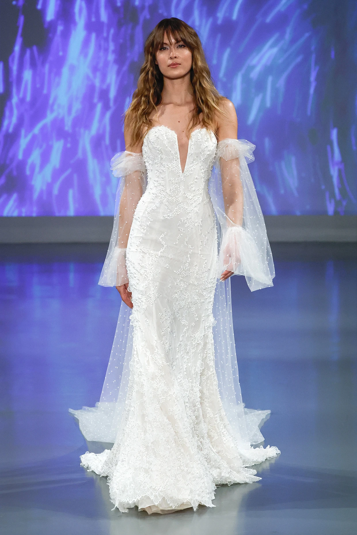 A model walks a runway wearing the Ines Di Santo Clementine dress