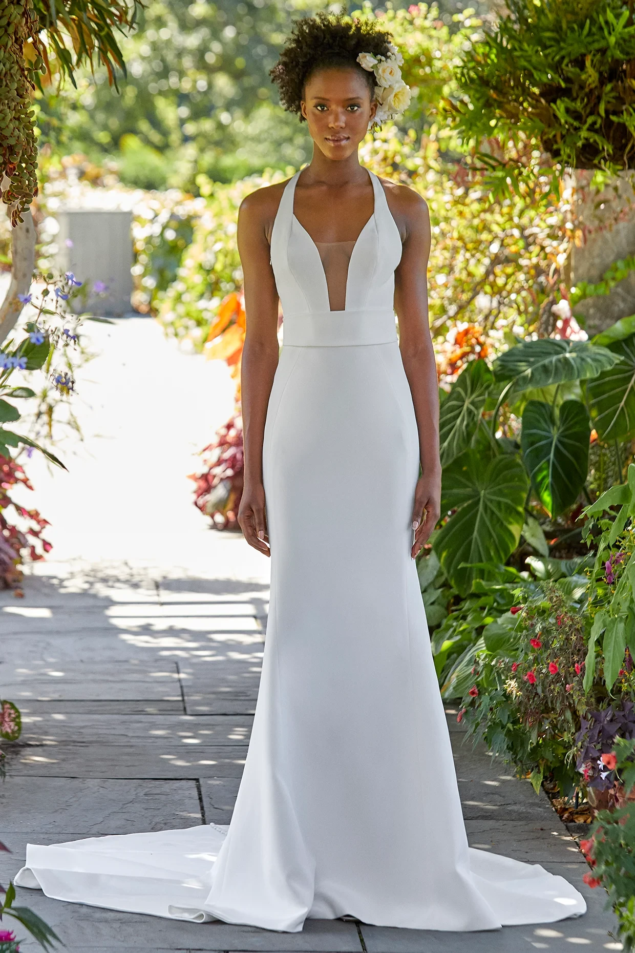 A model wears the Ines Di Santo Miuccia dress in a garden