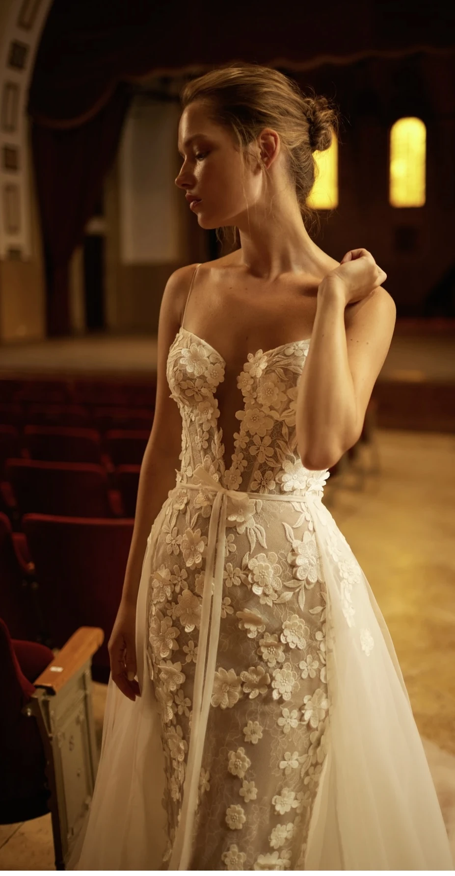 A model wears the Arava Polak Zoya dress in the aisle of a theater