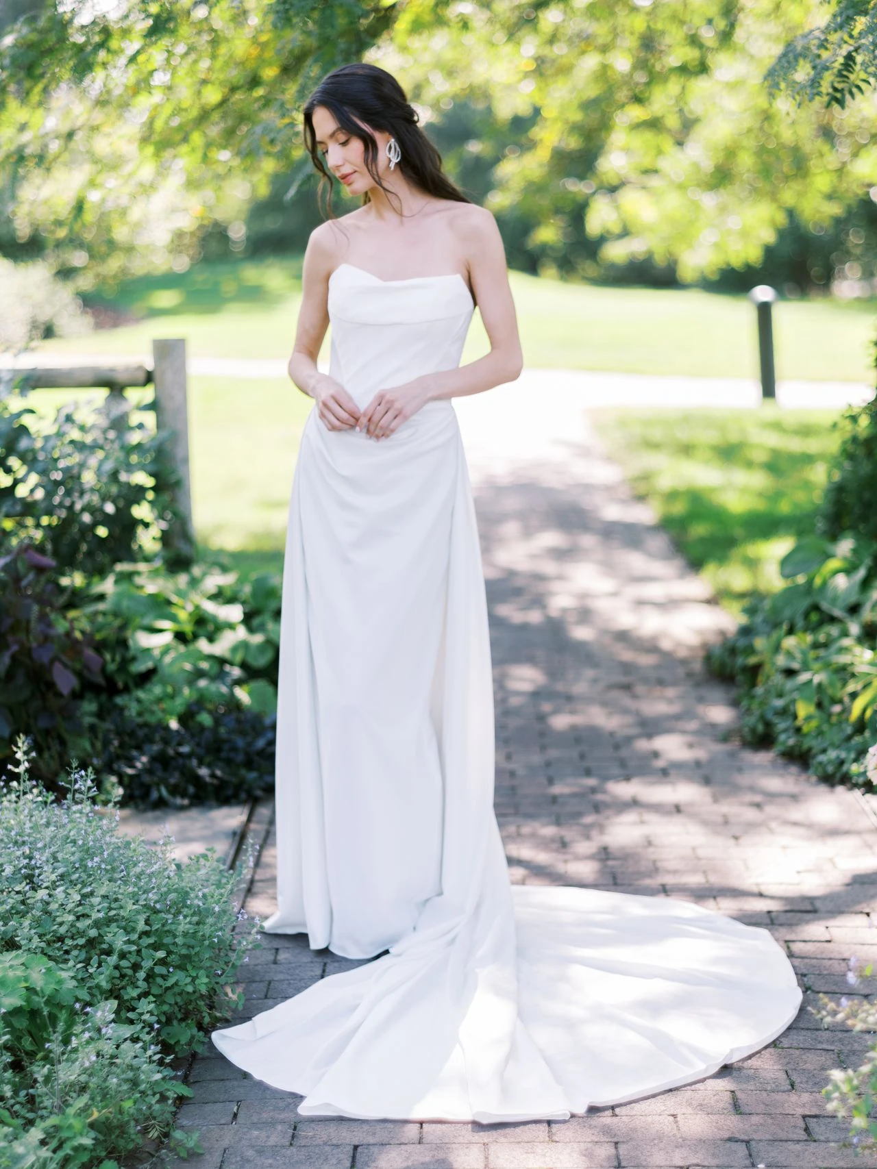 A model wears the Atelier Beccar Cannes dress in a garden