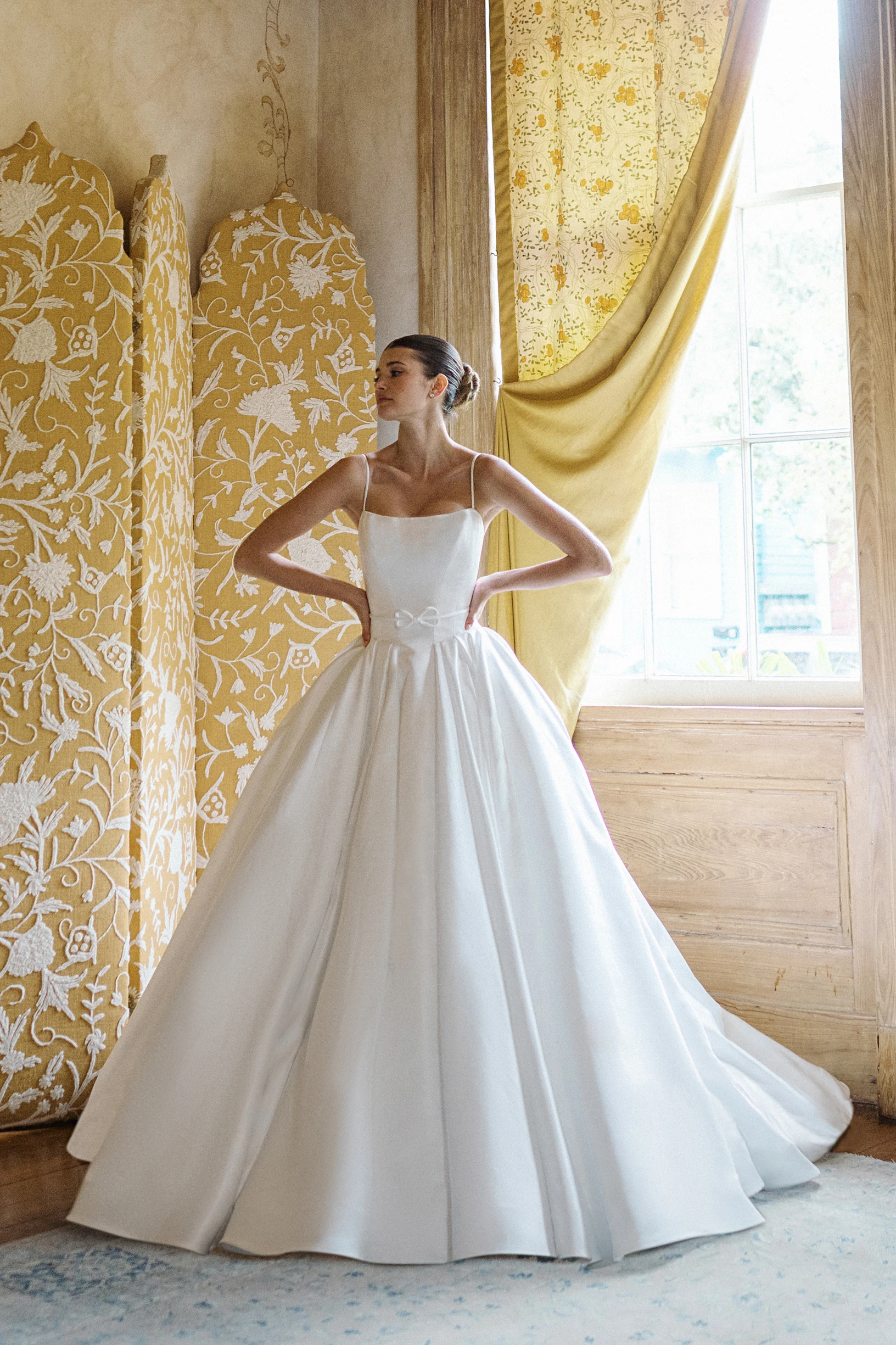 A model wears the Anne Barge Monde dress in the fitting room of a large mansion