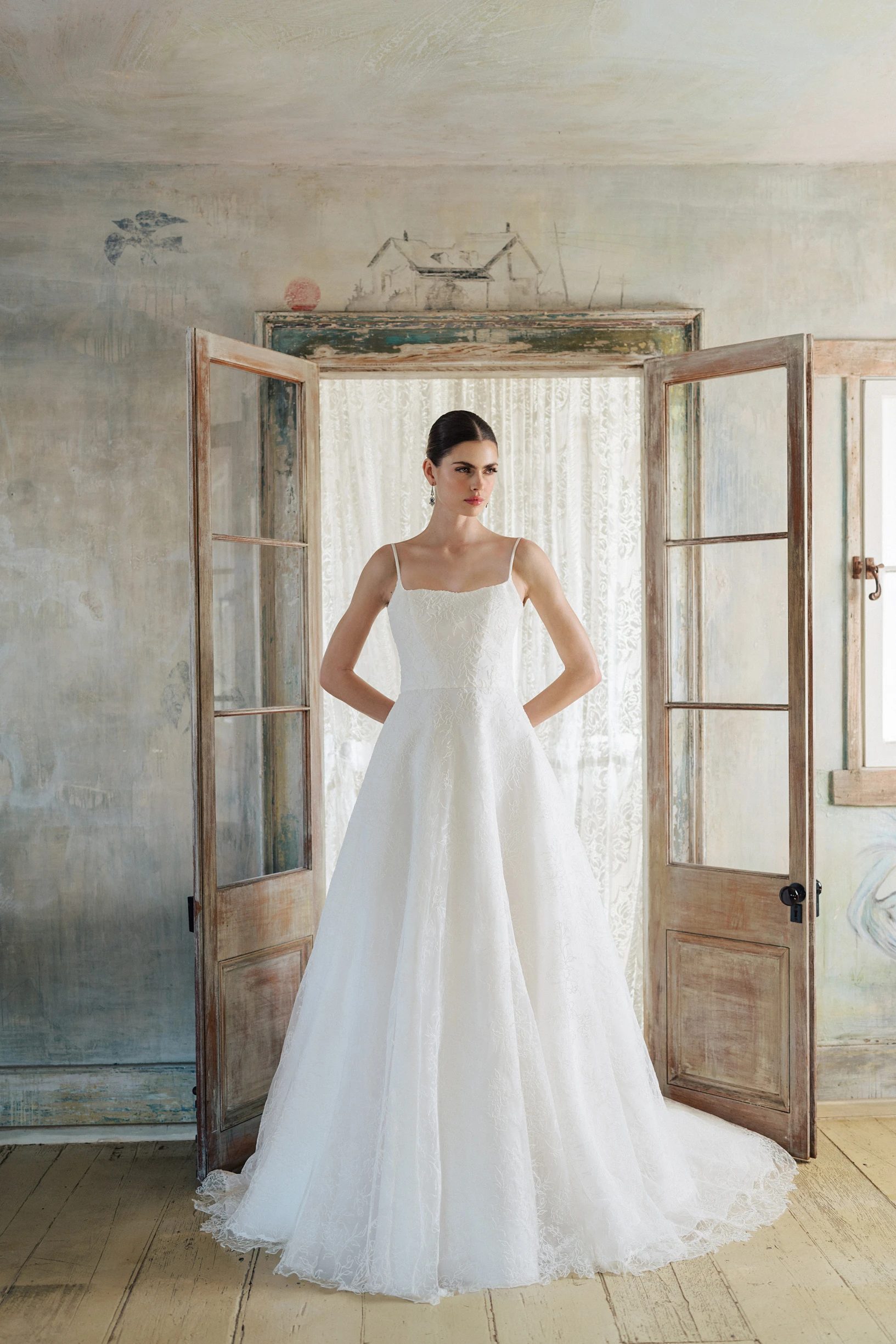 A model wears the Anne Barge Brennen dress in a rustic doorway