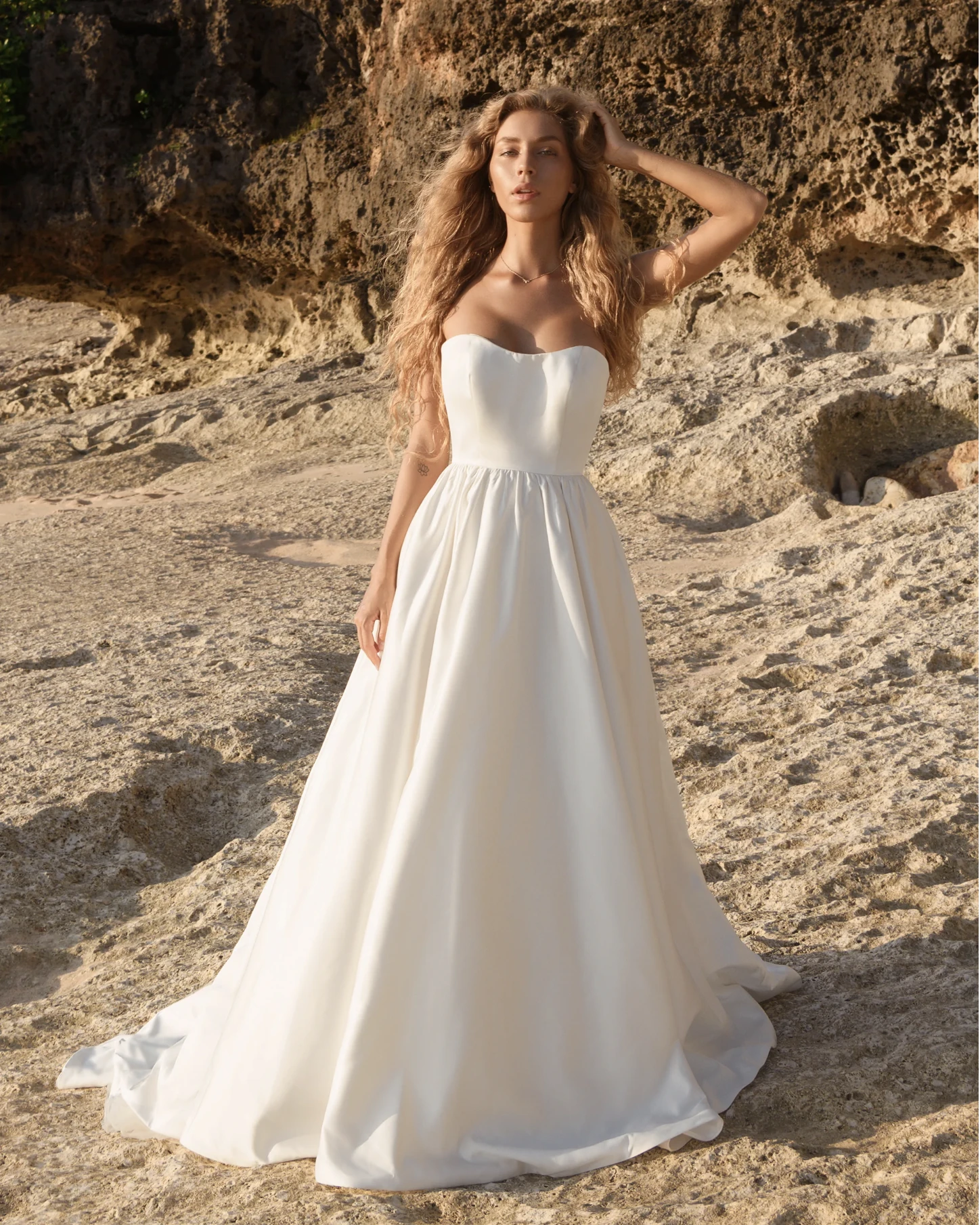 A model wears the Antonio Gual Ionna dress on a beach