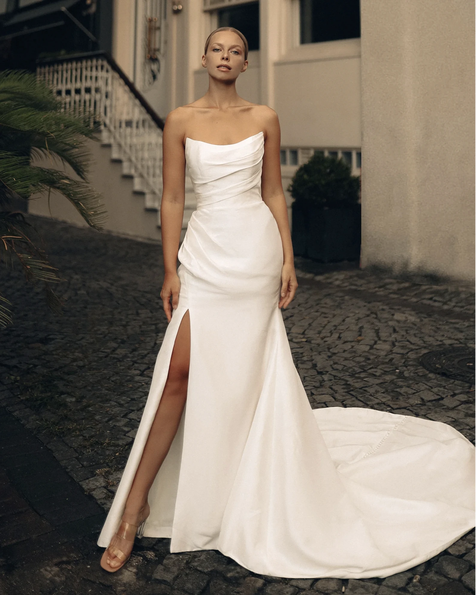 A model wears the Antonio Gual LP dress on a cobblestone street