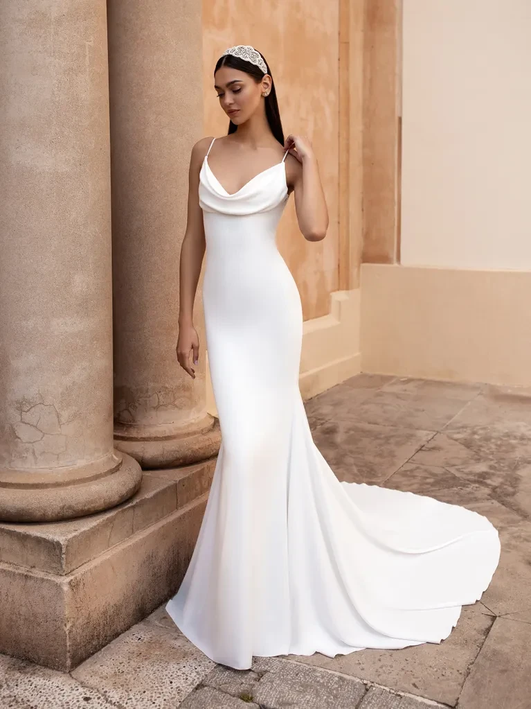 A model wears the Pronovias Antiope dress near stone columns