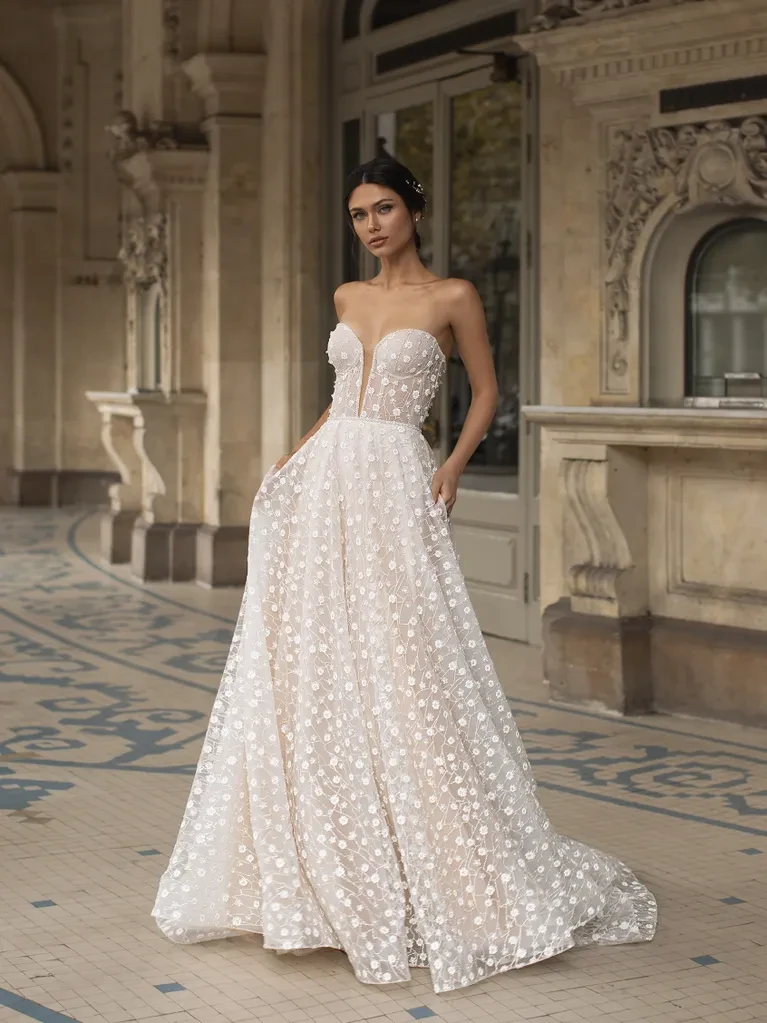 A model wears the Pronovias Hopkins dress in the lobby of a high-end hotel